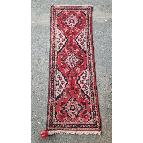 135 - Star Lot : A lovely hand woven woolen runner rug in shades of red, pink and blue. All hand knotted w... 