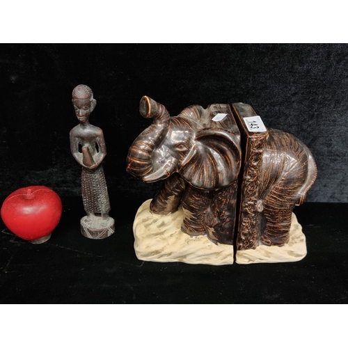 143 - A characterful pair of ceramic book ends in the form of an African elephant. Finished in a dark brow... 