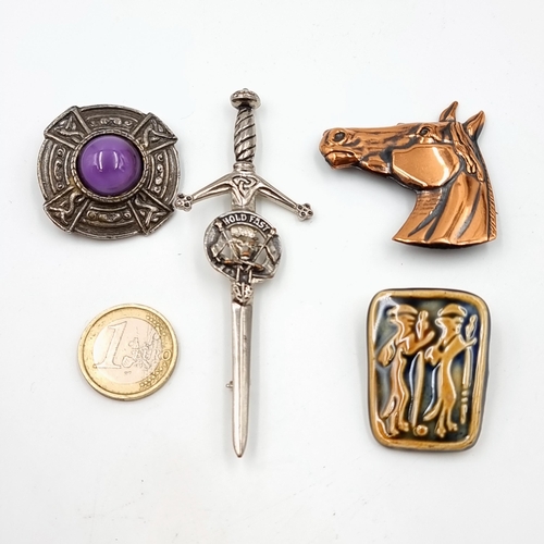 15 - An excellent collection of four assorted brooches, featuring an unusual ceramic tiled example, A Sco... 