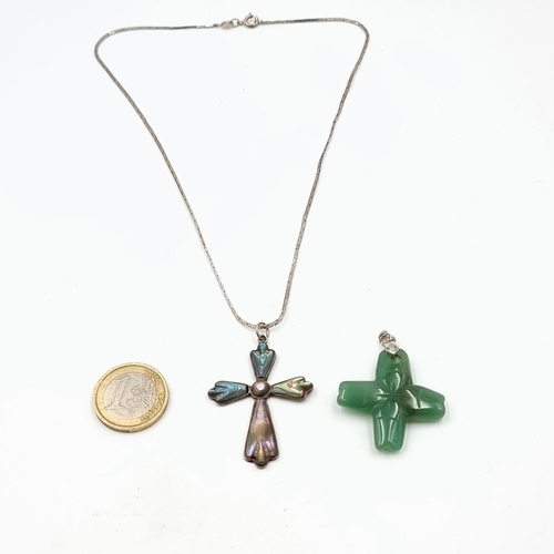 16 - Two pendants, the first is a Abalone cross example which features a Sterling silver chain. Length: 4... 
