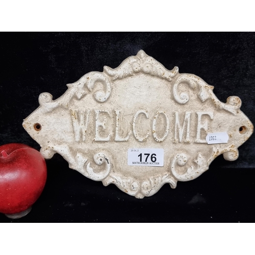 176 - A pretty cast metal wall plaque reading 'Welcome' and featuring scroll detailing.