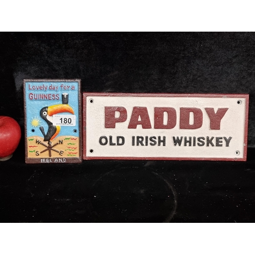 180 - Two heavy cast metal wall plaques with one reading 'Paddy Old Irish Whiskey' and another advertising... 