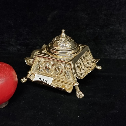 242 - A fabulouse heavy polished brass inkwell with profuse curvilinear foliate design, held on lions claw... 