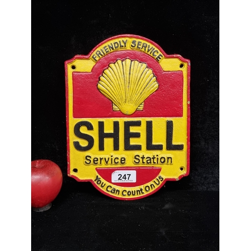 247 - A heavy cast metal wall sign reading Shell with he logo above in bright red and yellow.