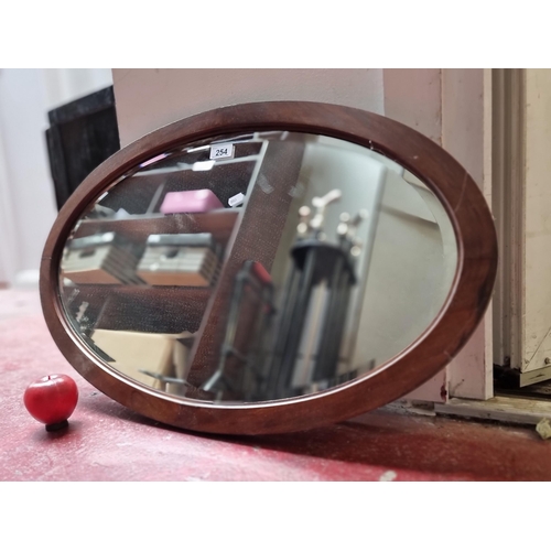 254 - A fabulous antique oval wall mirror with solid wood frame and chain to back.