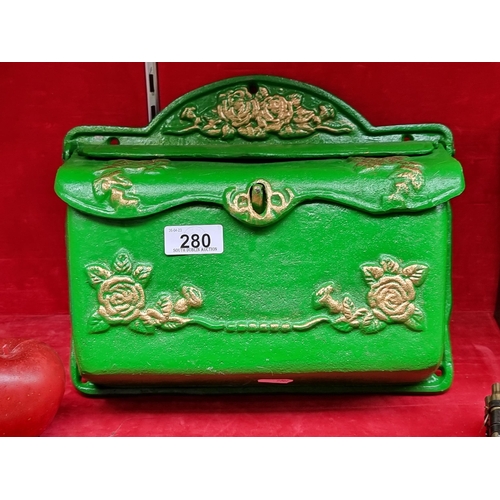 280 - A wonderful very heavy cast metal letter box in a forest green finish with a lid to top and floral g... 