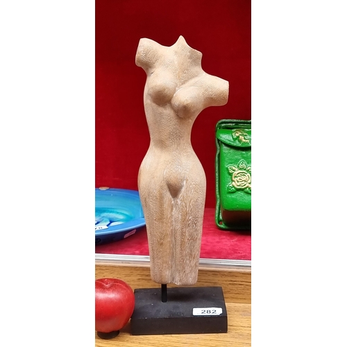 282 - An elegant wooden sculpture depicting a female form stood on a black square base.