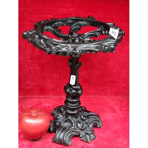 283 - A very heavy cast metal plant stand / trivot with profuse foliate detail throughout. In a matte blac... 