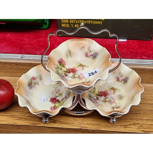 284 - A very pretty tiered serving bowl stand with three ceramic bowls featuring scallop edges and a flora... 