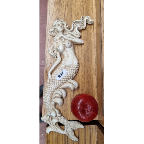 288 - A fantastic heavy cast metal wall decoration depicting a mermaid with flowing hair. In a cream finis... 