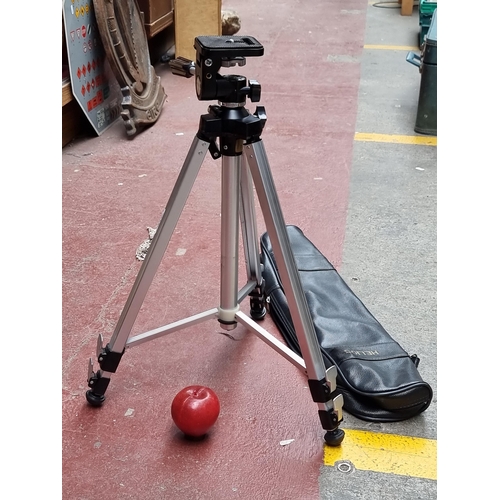 292 - A Helios camera tripod, model T-1. With adjustable height, a rotating platform and original leather ... 