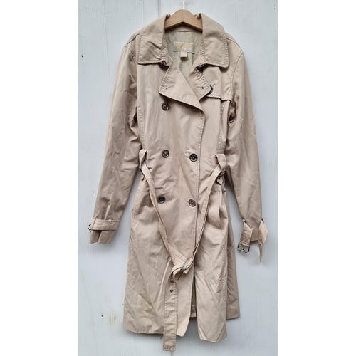 327 - A stylish ladies double brested trench coat by Michael Kors in a light beige finish, chrome buttons ... 