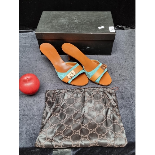 331 - STAR LOT : A pair of very stylish as new genuine Gucci heeled sandals with a turquoise strap featuri... 