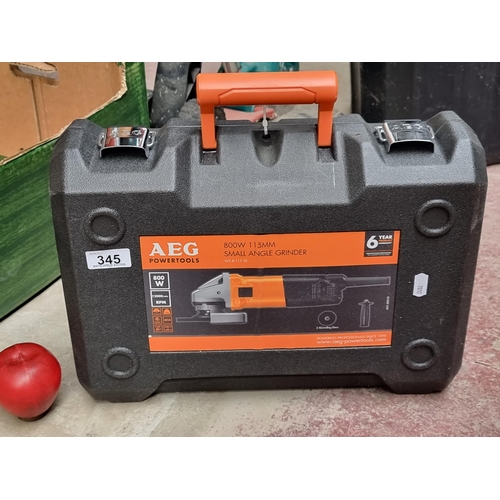 345 - An AEG Powertools 800w small angle grinder with two grinding discs. Complete with original hard shel... 