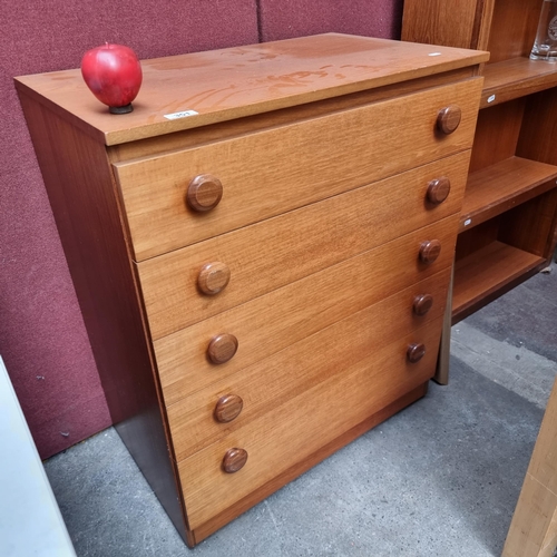 351 - A solid teak mid century modern pine chest of drawers with five drawers and large bun handles. H84cm... 