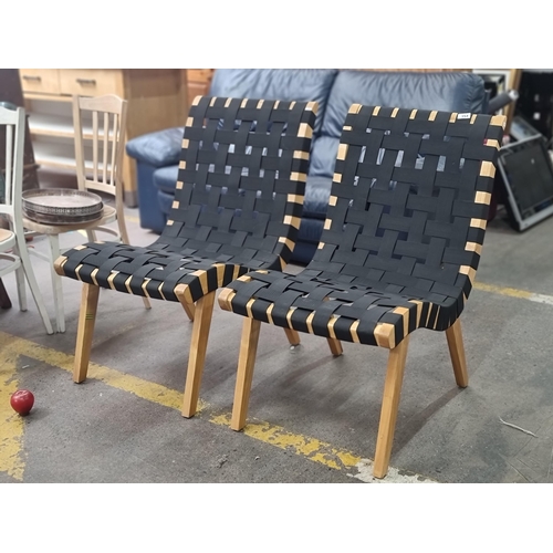 354 - A pair of stylish chairs with woven seats crafted from wide elastic straps on well made wooden frame... 