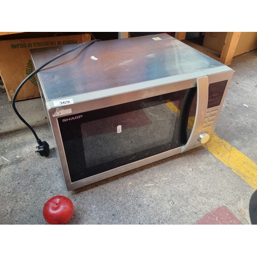 369 - A Sharp branded stainless steal microwave. Model number R-822STM. 900w with grilling platform.