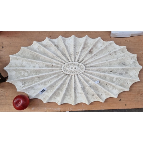 386 - A large antique  plaster cast ceiling rose. Featuring a central floral cartouche and a radiating sun... 