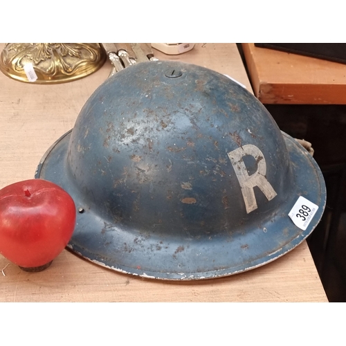 389 - A genuine vintage Brodie helmet. A British military helmet circa WWII. Featuring a hand applied ''R'... 