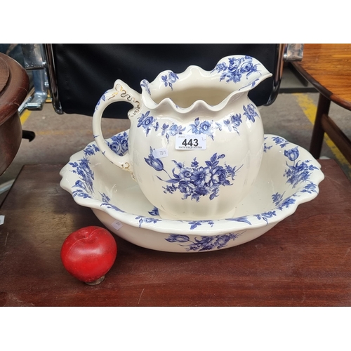 443 - A large ceramic washing basin and pitcher, both decorated with delicate blue and white floral border... 