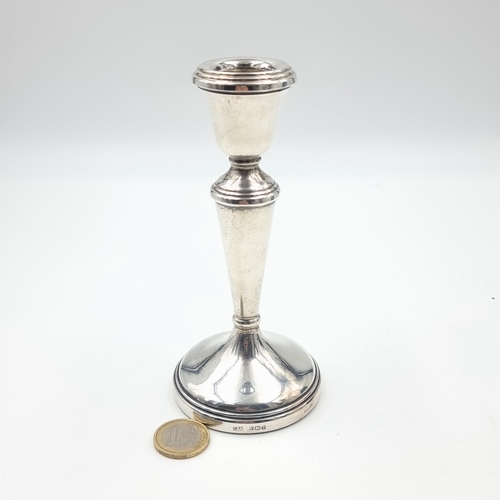 5 - An elegant example of a sterling silver candle stick, featuring a finely graduated base and attracti... 