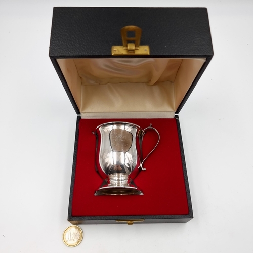 54 - A nice example of an Irish silver presentation cup, featuring a flying C handle, nicely formed body ... 