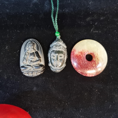 660 - Three polished Chinese stone pendants. Including two beautifully carved Buddha pendants, carved from... 