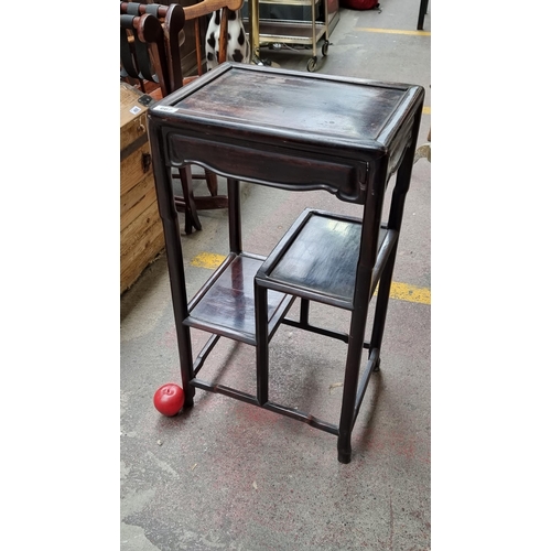 667 - A lovey Chinese rosewood display table with recessed paneling to top, and a two tier shelf below. He... 