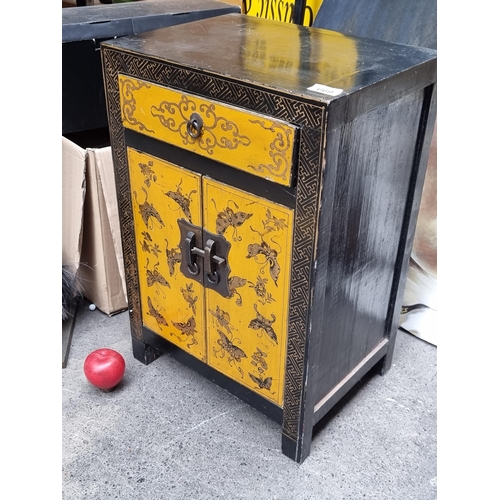 669 - A beautiful Japanese laquered wood cabinet with two door cupboard and a single drawer boasting stunn... 