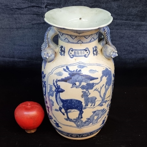 674 - A large and striking Chinese ceramic vase. Featuring large figural pomegranate handles and an unusua... 