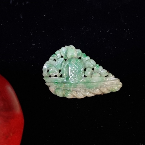 682 - A large carved jade brooch featuring a bird perched on a water feature with water lapping at the bas... 