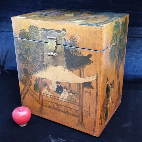 701 - A large Chinese inspired storage chest. Featuring a rich golden stain and a peaceful scene of schola... 