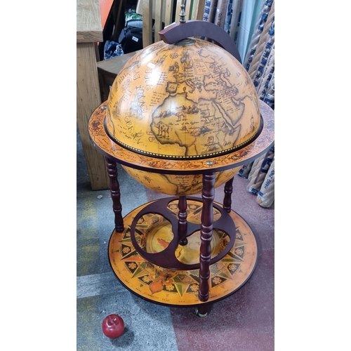 850 - Star lot : A fantastic floorstanding globe which opens to reveal a cocktail cabinet within. Features... 