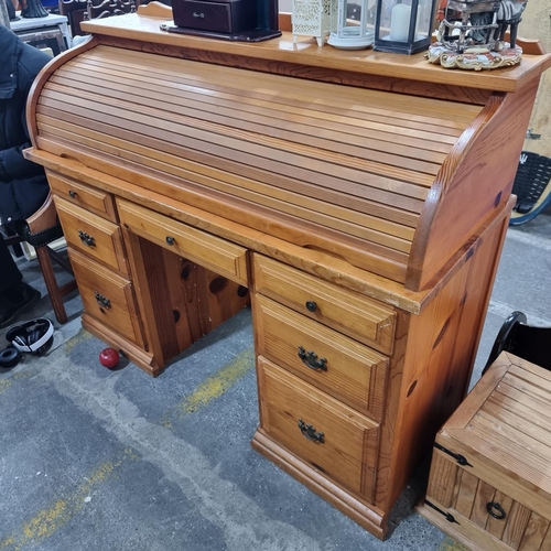 856 - A solid pine roll top desk with gallery back to top, three shelf compartments to back, along with se... 