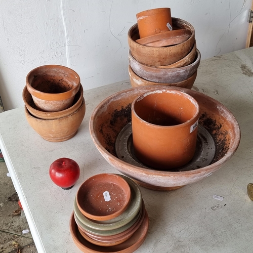 910 - Twenty good quality terracotta planters and plates in a variety of sizes.