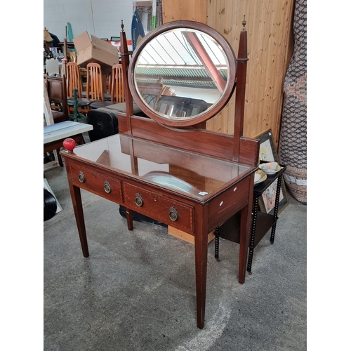 934 - An exquisite antique Edwardian dressing table. This well crafted example features a central tilt top... 