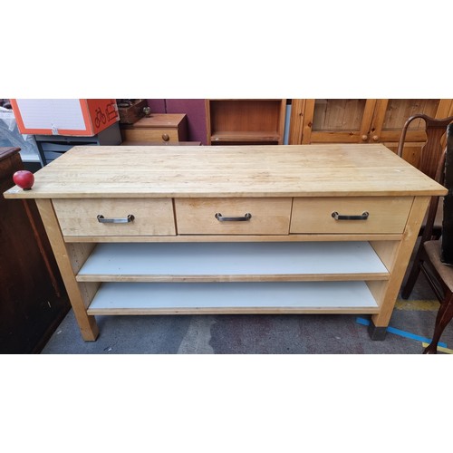 352 - A large kitchen unit with three deep drawers and two full length shelves to base. With a removable t... 