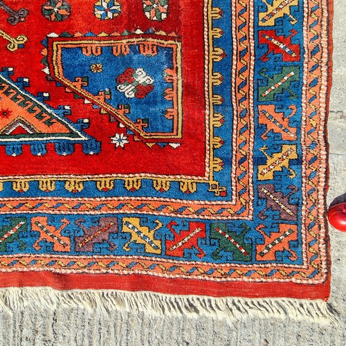 752 - Star lot : A beautiful  large handknotted wool rug. Designed in a rich palette of reds and blues wit... 