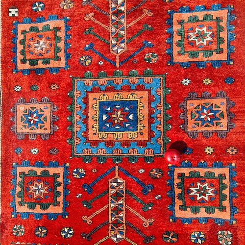 752 - Star lot : A beautiful  large handknotted wool rug. Designed in a rich palette of reds and blues wit... 