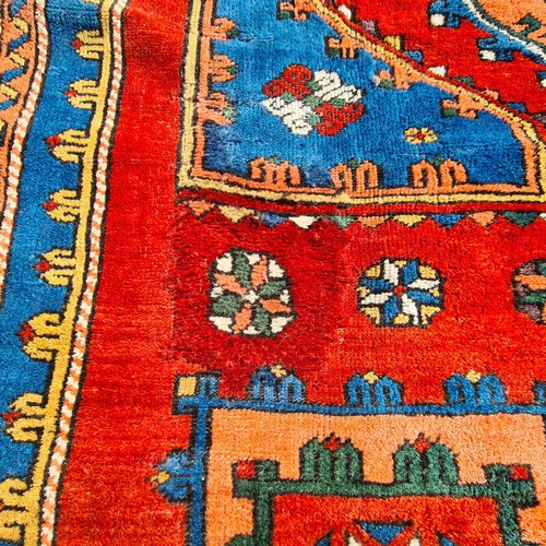 752 - Star lot : A beautiful  large handknotted wool rug. Designed in a rich palette of reds and blues wit... 