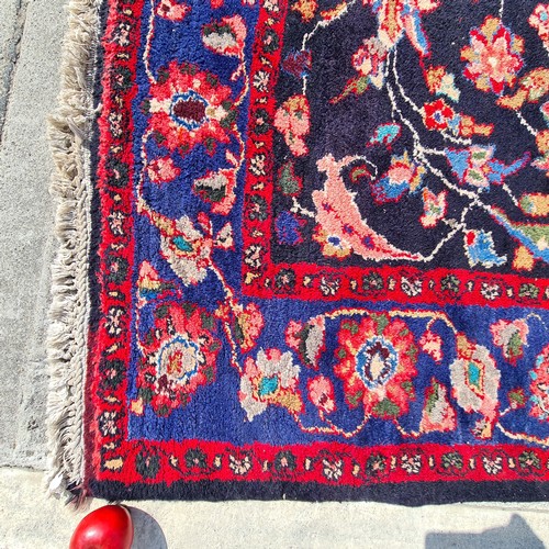 767 - Star Lot : A beautiful large handknotted vintage floor rug in rich shades of blue and fuchsia with g... 