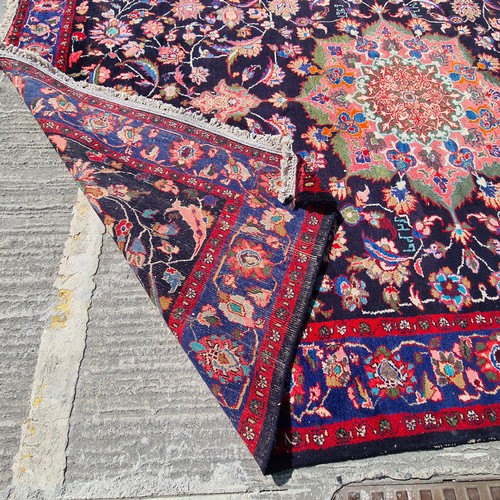 767 - Star Lot : A beautiful large handknotted vintage floor rug in rich shades of blue and fuchsia with g... 