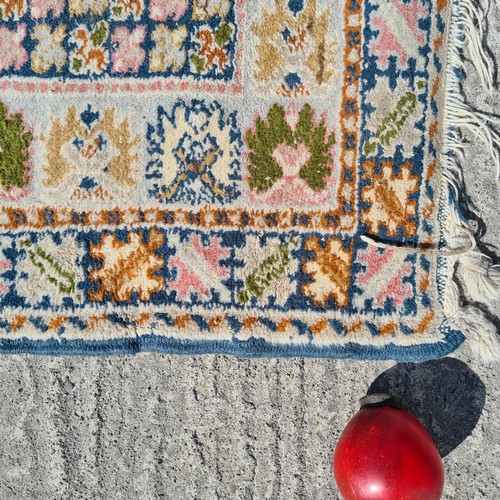 803 - A lovely vintage handknotted rug from Morocco. This charming example is designed in shades of blue w... 