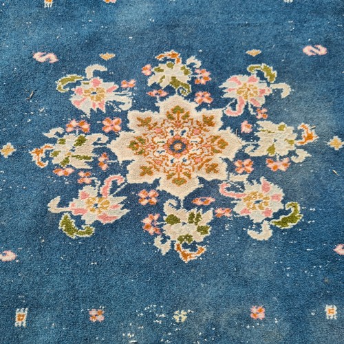 803 - A lovely vintage handknotted rug from Morocco. This charming example is designed in shades of blue w... 