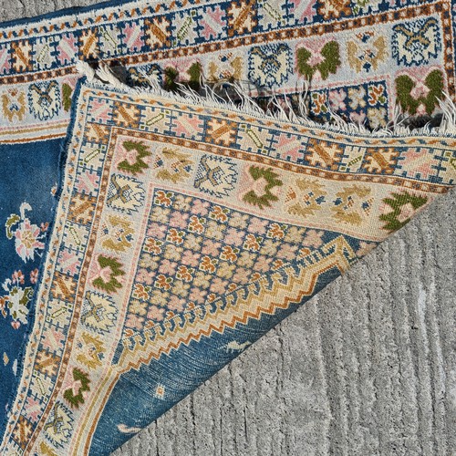 803 - A lovely vintage handknotted rug from Morocco. This charming example is designed in shades of blue w... 