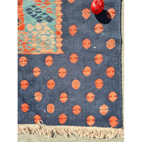 804 - A large Turkish rug in shades of red and blue and geometric design. With cream fringe L310cm x W200c... 