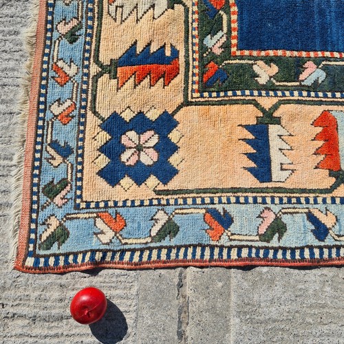 805 - Star lot : A large handknotted vintage Anatolian Turkish rug. Designed in shades of blues, peaches a... 