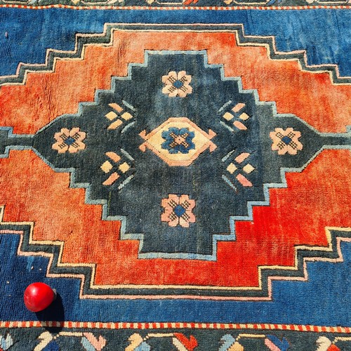 805 - Star lot : A large handknotted vintage Anatolian Turkish rug. Designed in shades of blues, peaches a... 