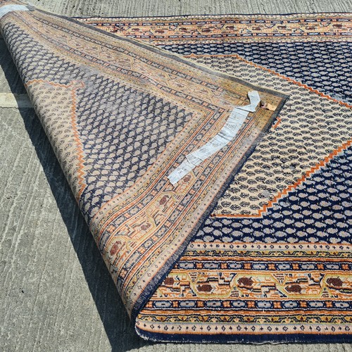 741 - A large hand knotted Persian rug in a blue and cream pattern with orange detailing. Some wear as pic... 