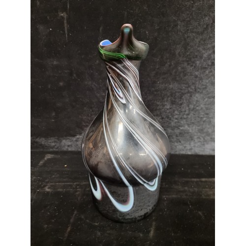 127 - Star Lot : A fantastic ceramic pitcher in a dark glaze with a bright blue glazed interior that is pu... 